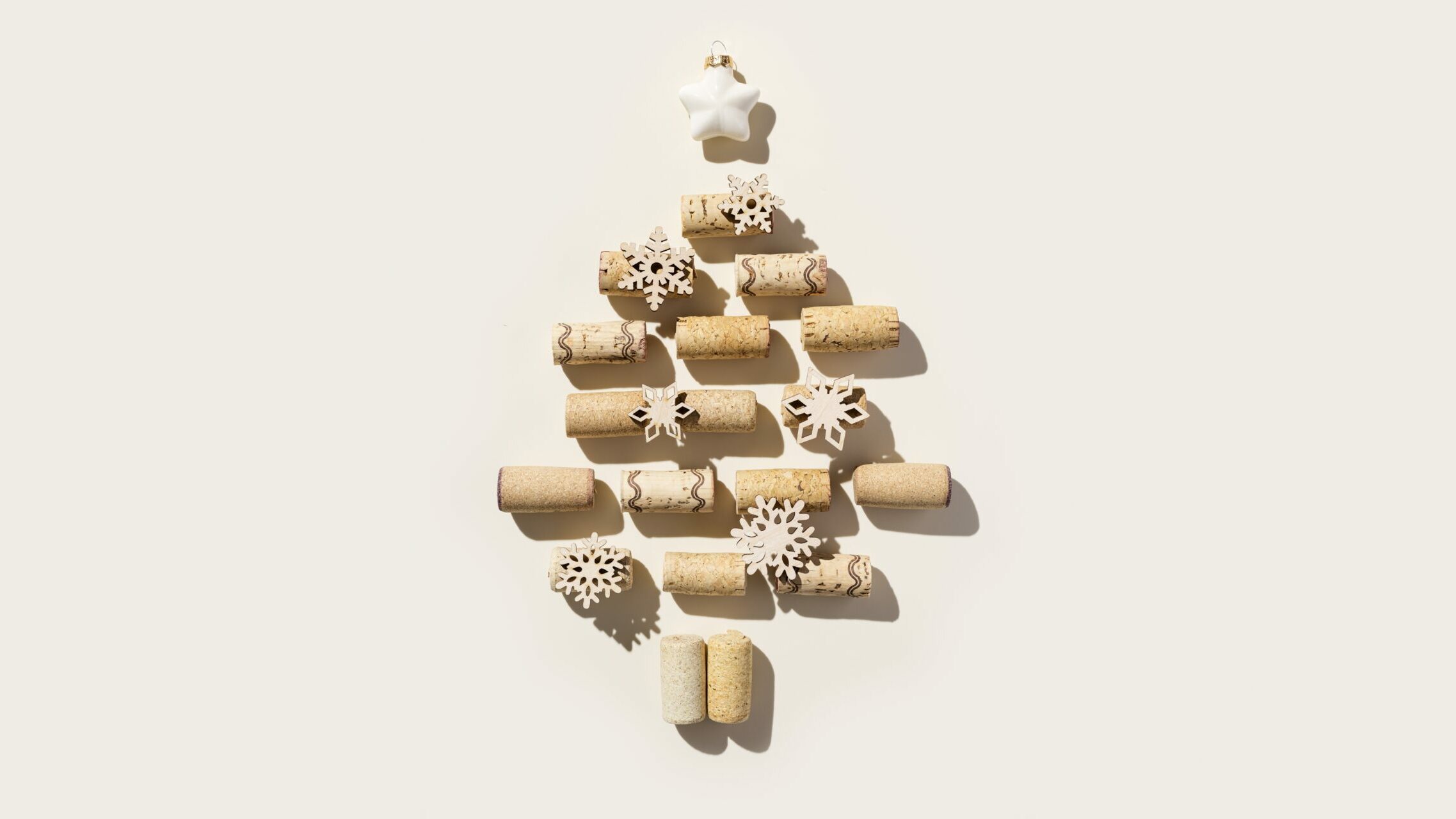 wine,corks,as,christmas,tree,on,beige,background,,sun,shadows.